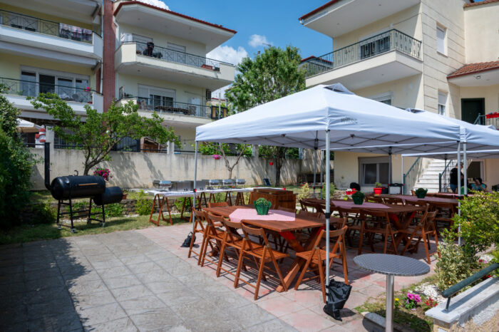 Texas BBQ catering setup with outdoor tables and canopy at backyard event