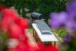 Texas BBQ buffet table and smoker grill in backyard garden