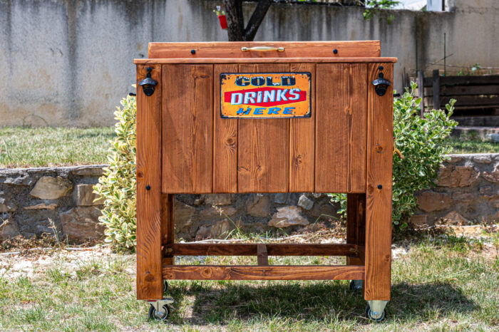 Close-up of vintage cold drinks wooden cooler at outdoor catering