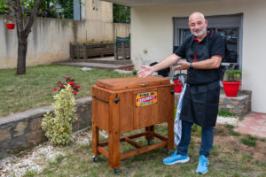 BBQ chef presenting cold drinks cooler at Texas smoked BBQ catering
