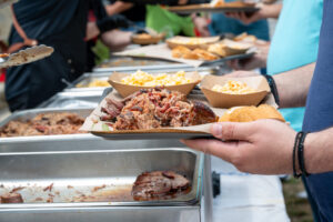 Close-up of plate with smoked pulled pork, mac and cheese, and coleslaw at BBQ catering