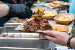 Close-up of smoked pulled pork with roasted potatoes served at Texas BBQ buffet