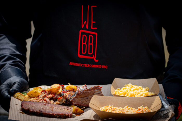 BBQ plate with sliced brisket, pulled pork, roasted potatoes, mac and cheese and coleslaw